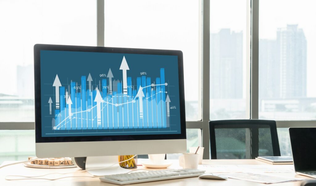 A computer screen displays graphics representing business growth