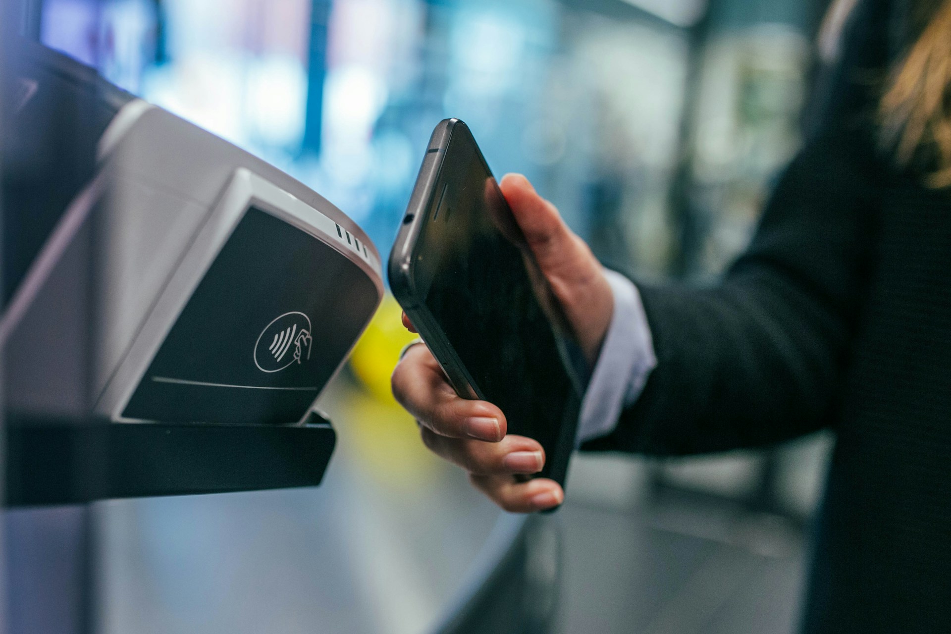A close-up of someone paying contactless using their smartphone