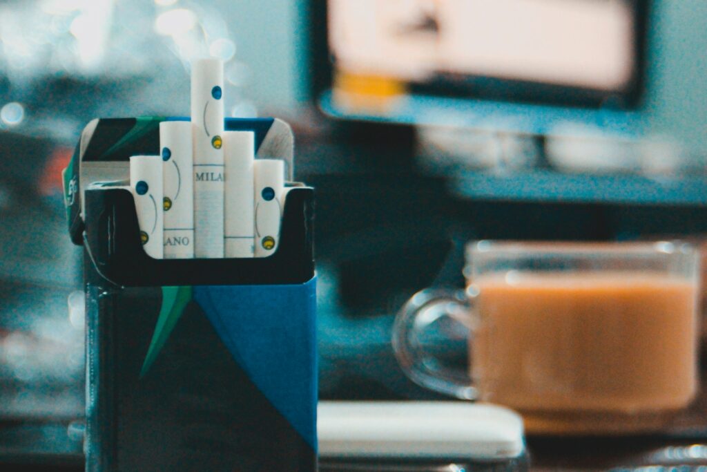 An aesthetic shot, close-up, of a pack of cigarettes on an active desk