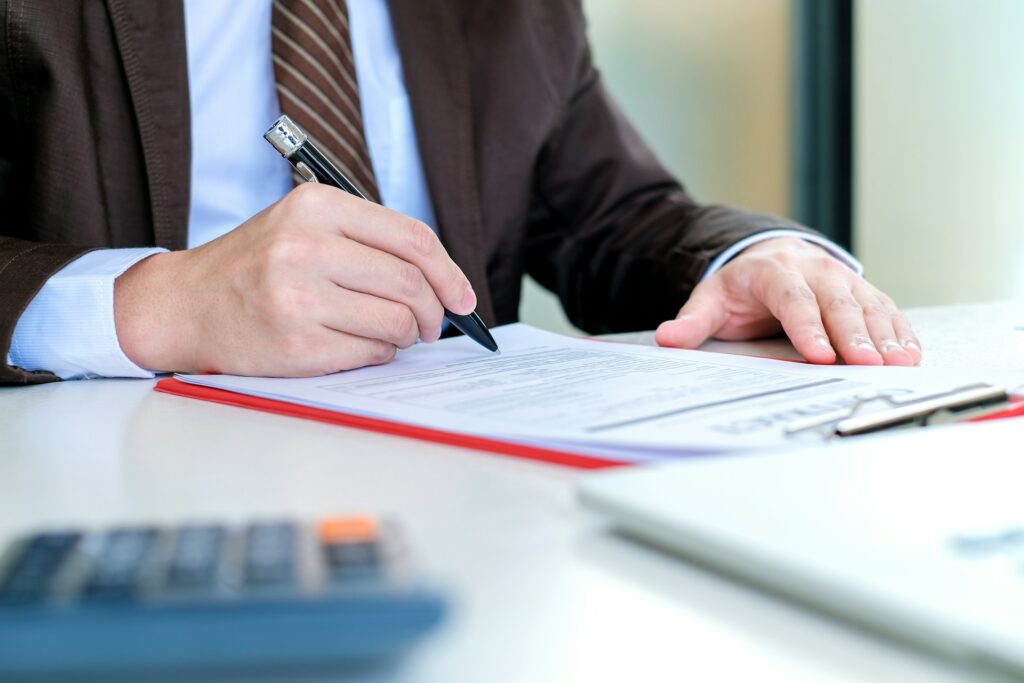 A business owner sits filling out bank paperwork trying to register his business