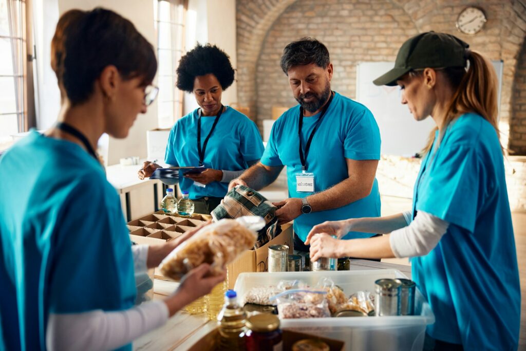 What is de-risking — and why is it happening to your business? 4 A group of charity worker volunteers on site, charities being one of the organizations at risk from banks