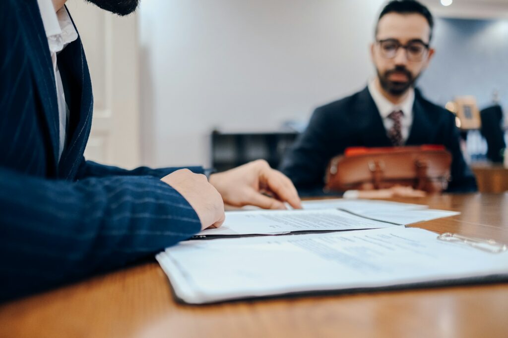 What is de-risking — and why is it happening to your business? 1 A banker looks over documentation while working in de-risking with a business