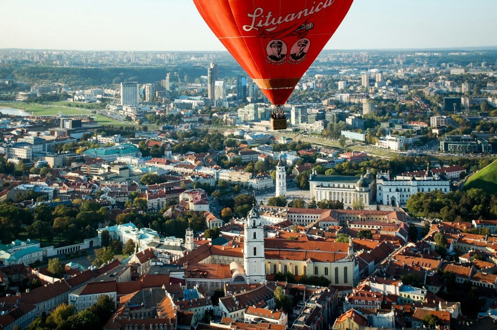 Hot air balloon over vilnius old town with the cathedral bell tower below, concept image for how to open a business bank account in lithuania as a uk company